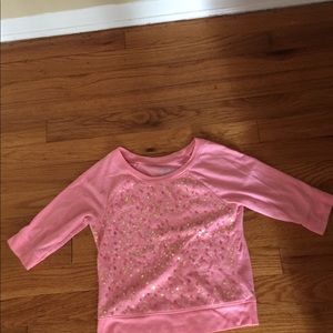 A pink, half cut sleeved tee.